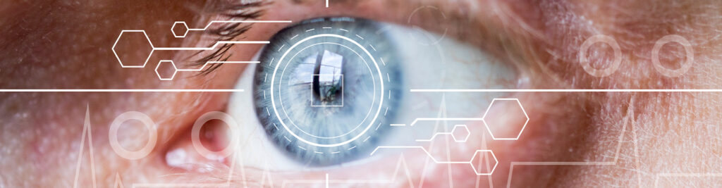 osoba z czerwonymi oczami pocierająca powieki przed ekranem komputera w ciemnym pokoju