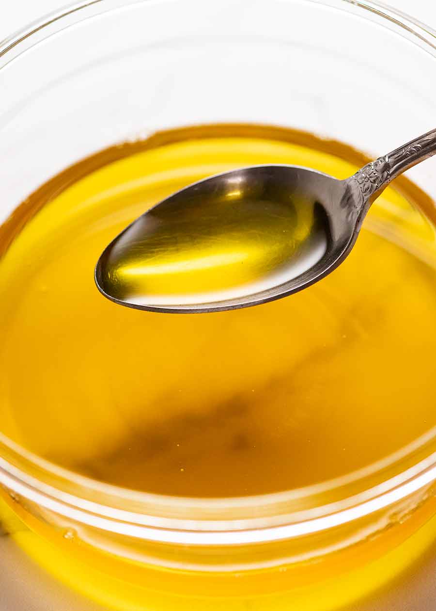 Ghee posmarowane na świeżym chlebie miseczka ghee obok kromki chleba posmarowanej złotą masą